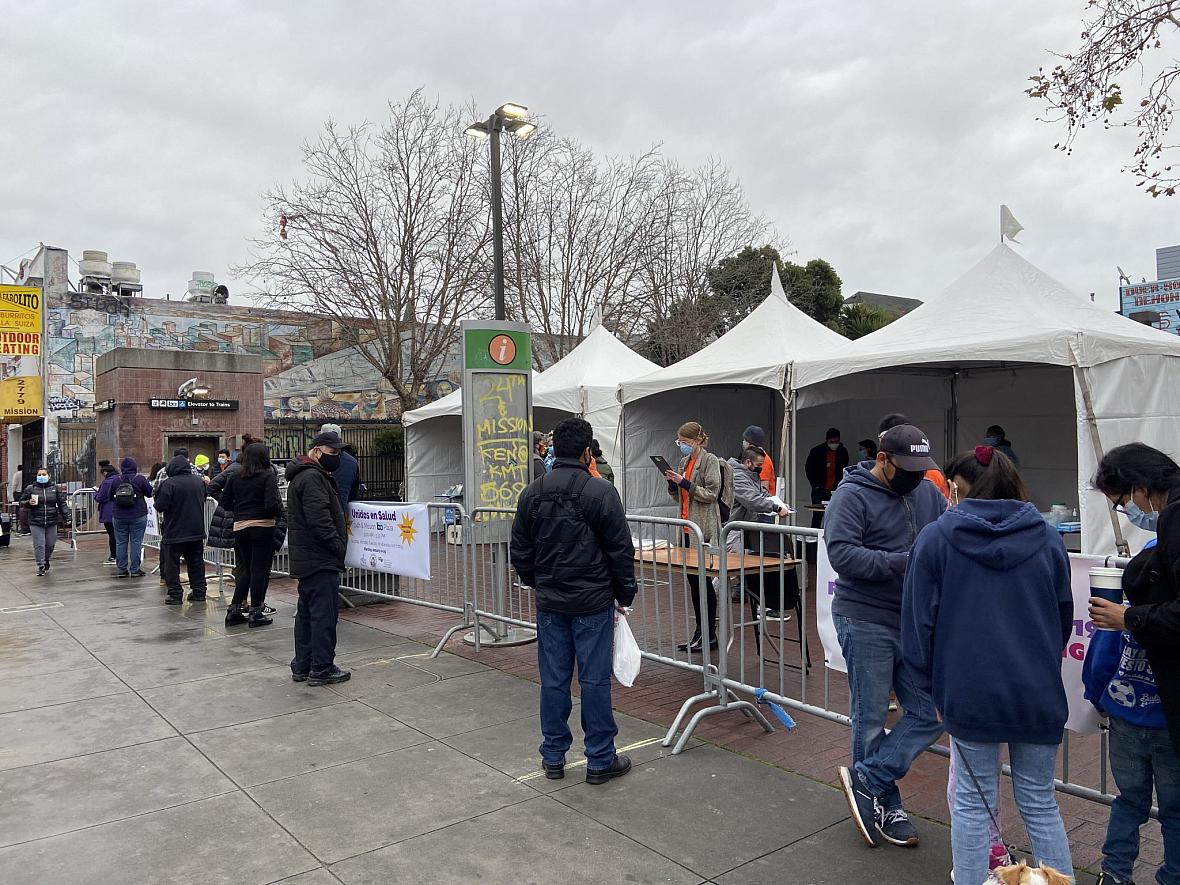 As people wait to take the Binax rapid test at 24th St. Mission BART Station Plaza, they fill out online surveys that question t