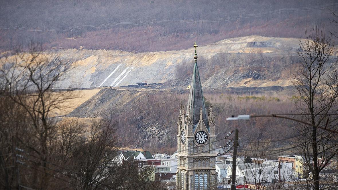 The steeple of the now closed St. Katharine Drexel Roman Catholic Church stands out in front of the skyline of Lansford as you e