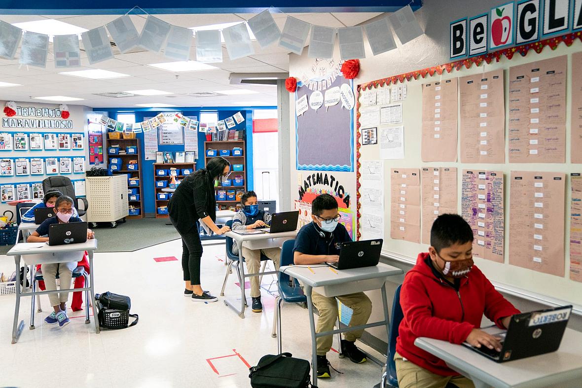 Fifth-grade teacher Uyslamis Echeverria-Ramos helps a student at RCMA Immokalee Community School in Immokalee.