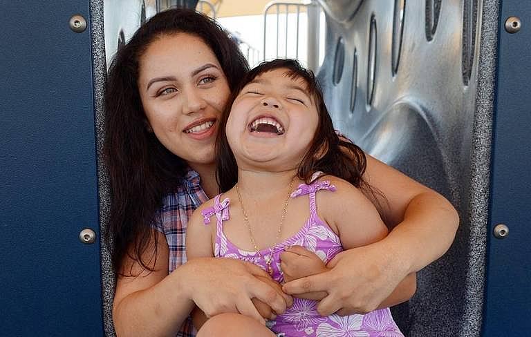 Graciela Pacheco plays with her daughter, Alyssa Sherlynne, during a visit to Inspiration Park in Fresno on June 1, 2017.