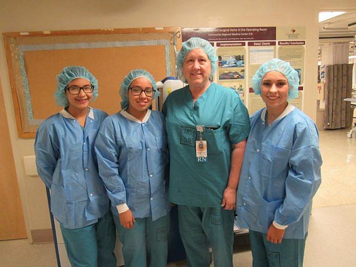 Doctors Academy students Yesenia Avina, Jennifer Becerra and Alexandra Snyder during a field visit with Debora Redondo, RN, BSN, CNOR at Community Regional Medical Center. Photo courtesy of USCF Fresno Doctors Academy. Doctors Academy students Yesenia Avina, Jennifer Becerra and Alexandra Snyder during a field visit with Debora Redondo, RN, BSN.