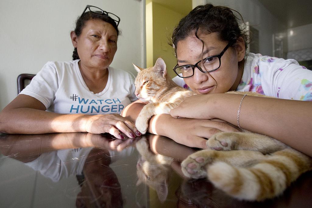 Orange Chicken the cat enjoys the late afternoon sun with his owner Carolina Torres and her mother Margarita Montes in Los Angeles on September 17th, 2016 Orange Chicken the cat enjoys the late afternoon sun with his owner Carolina Torres and her mother Margarita Montes.