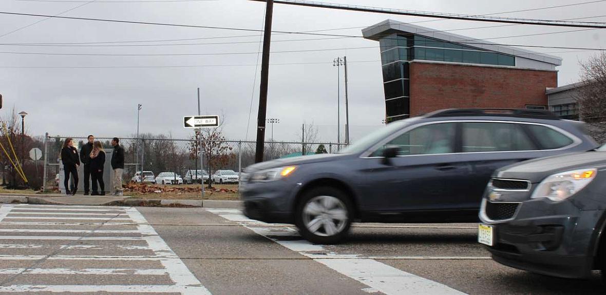 Drivers hurry past Burlington City High School on northbound Route 130.