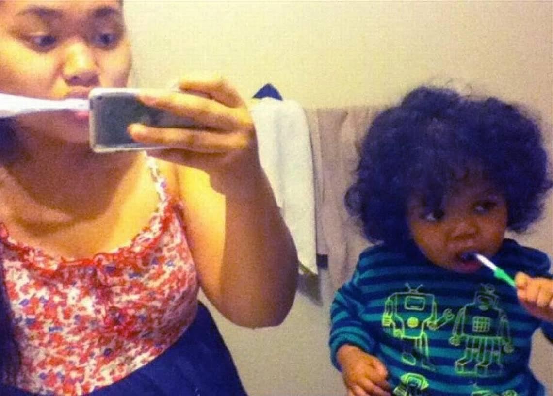 Judy Sinpraseuth and her son, Antwone, brush their teeth together, and take a picture in the mirror in 2012. Special to the Bee