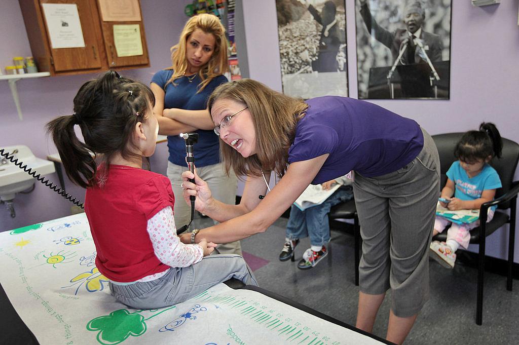 A girl is examined by a physician’s assistant in Aurora, Colo. (John Moore/Getty Images)