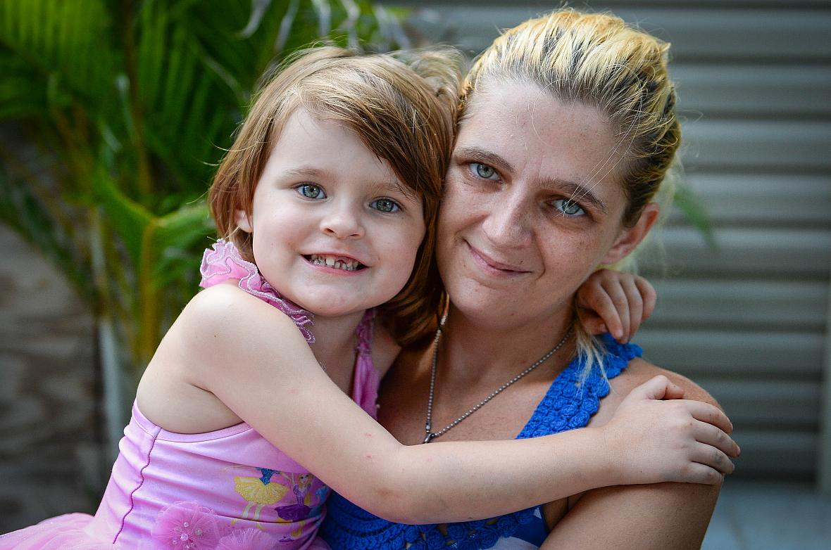 Keriana Carll, 4, and Megan Johnson pose in their yard in Bradenton. Johnson searched for months to find a dentist who was willi