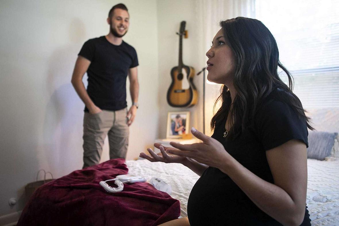 Marissa Mayberry, 28, talks as she sits on her bed and her husband Matthew, 28, listens at their home in Hondo, Texas on May 19,