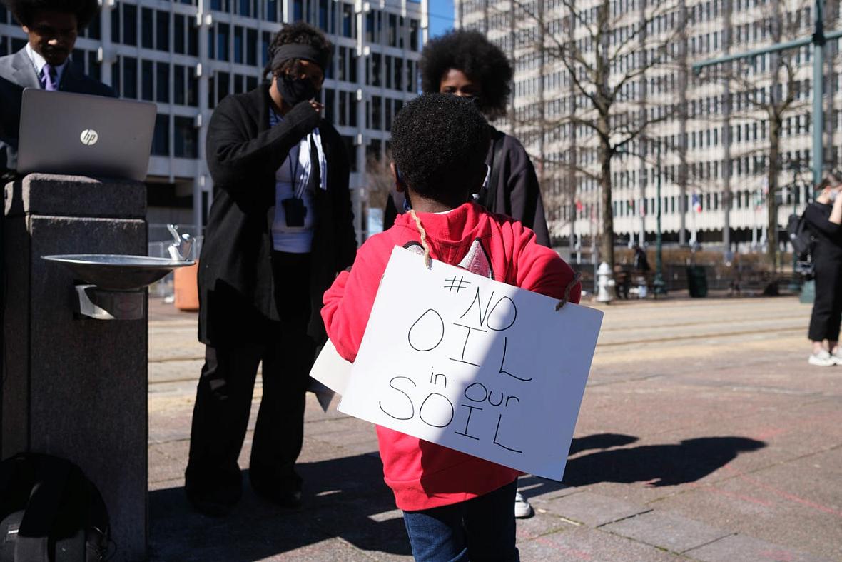 A young boy wears a sign outside of City Hall, protesting the construction of the Byhalia Connection Pipeline, Tuesday, Feb 23