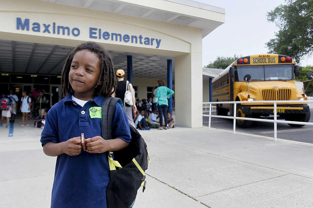 Kindergartner Tyree Parker waits for his grandmother, Loneiyce Washington, to pick him up from Maximo Elementary.