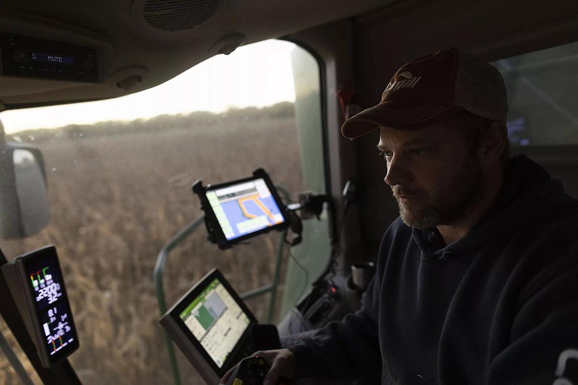 Farmer Jason Othmer operates a combine as he harvests corn near Vesta, an unincorporated community in Johnson County, on Tuesday