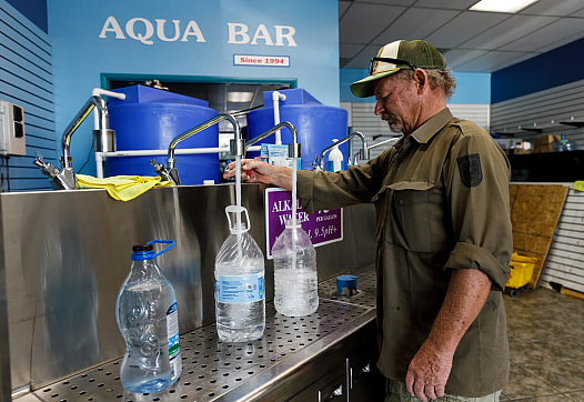 Person filling bottles with water