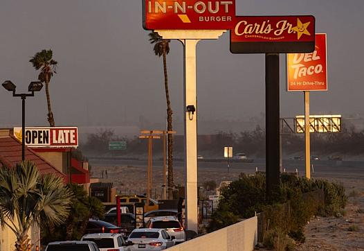 Cars wait in a queue amid several fast food restaurants in Southern California.
