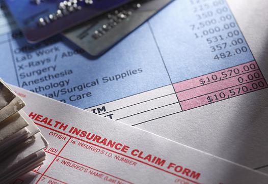 Medical bills on a desk.