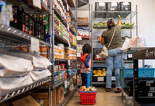 A family gathers food in the community pantry at the Central Texas Food Bank.
