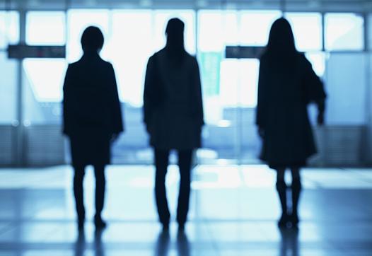 Three women in silhouette.
