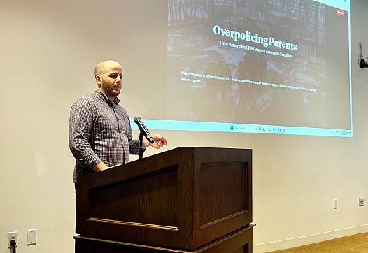 Eli Hager speaks at a podium.