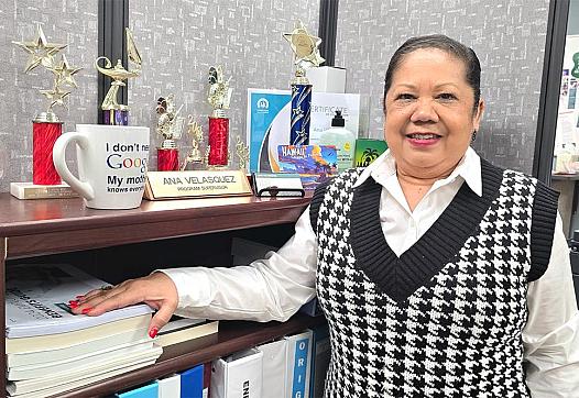 A woman stands in her office