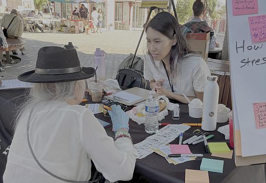 Two people taking at a community event
