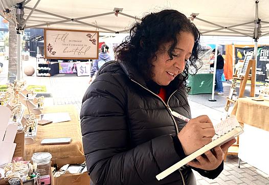 A Fresno vendor and breast cancer survivor Ana Barraza writes up a sale for a customer
