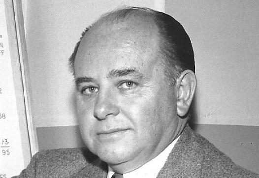 Black and white picture of a person wearing a suit