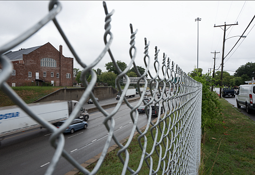 Road visible through a fence