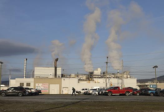 Smoke coming out of multiple chimneys of a building