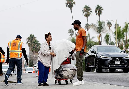 A city worker speaks to an unhoused person