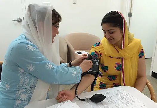 Person checking someone elses blood pressure