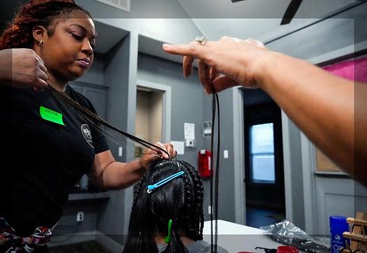 A person working on someones hair