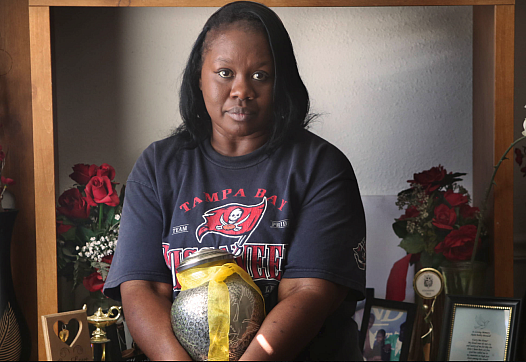 Patricia Davis, mother of Ikeim Boswell, holds the urn with her son’s ashes in her Tampa home. Ikeim was 16 on March 14, 2015, w