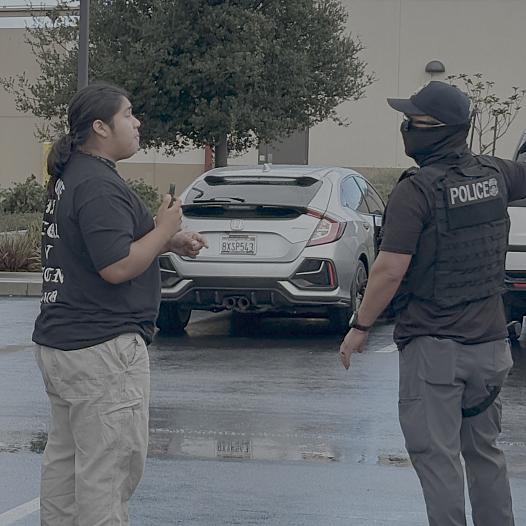 A person confronts an ICE officer 