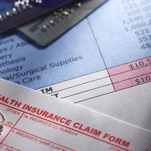 Medical bills on a desk.