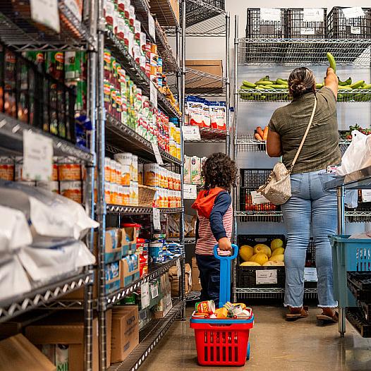 A family gathers food in the community pantry at the Central Texas Food Bank.