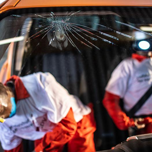 crash test dummies in a car with broken wind shield