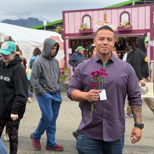 A person standing holding flowers in hand