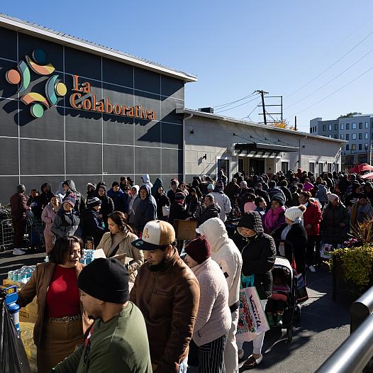 People waiting in line to pick up food 