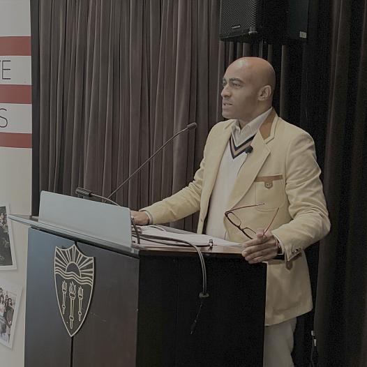 Lee Hawkins speaks at a podium.