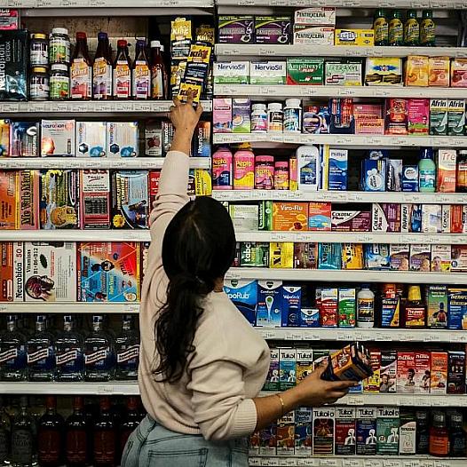 A person in a store reaching for an item