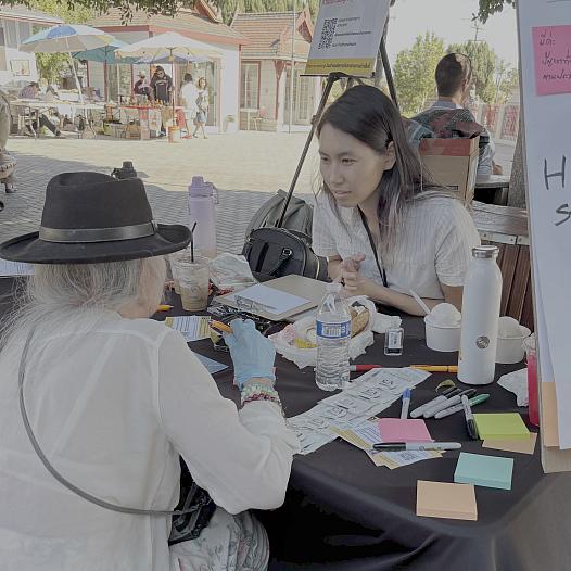 Two people taking at a community event