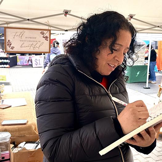 A Fresno vendor and breast cancer survivor Ana Barraza writes up a sale for a customer
