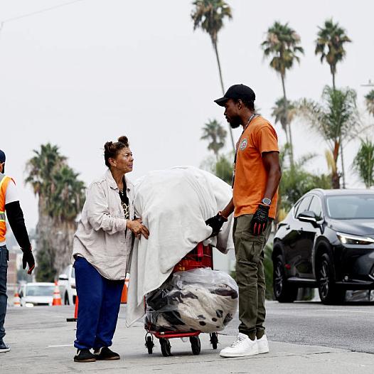A city worker speaks to an unhoused person
