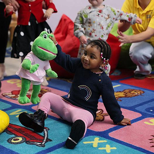 A child playing with a soft toy