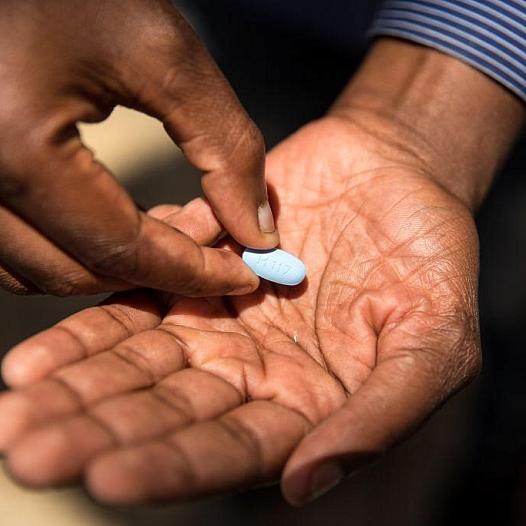 A person holding a pill