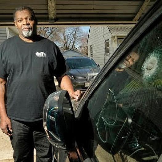 Pastor Kevin Simmons, who was shot during a carjacking, stands next to the Jeep he was in when he was shot