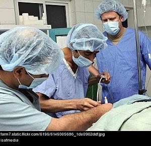 Doctors attending patient in hospital ICU