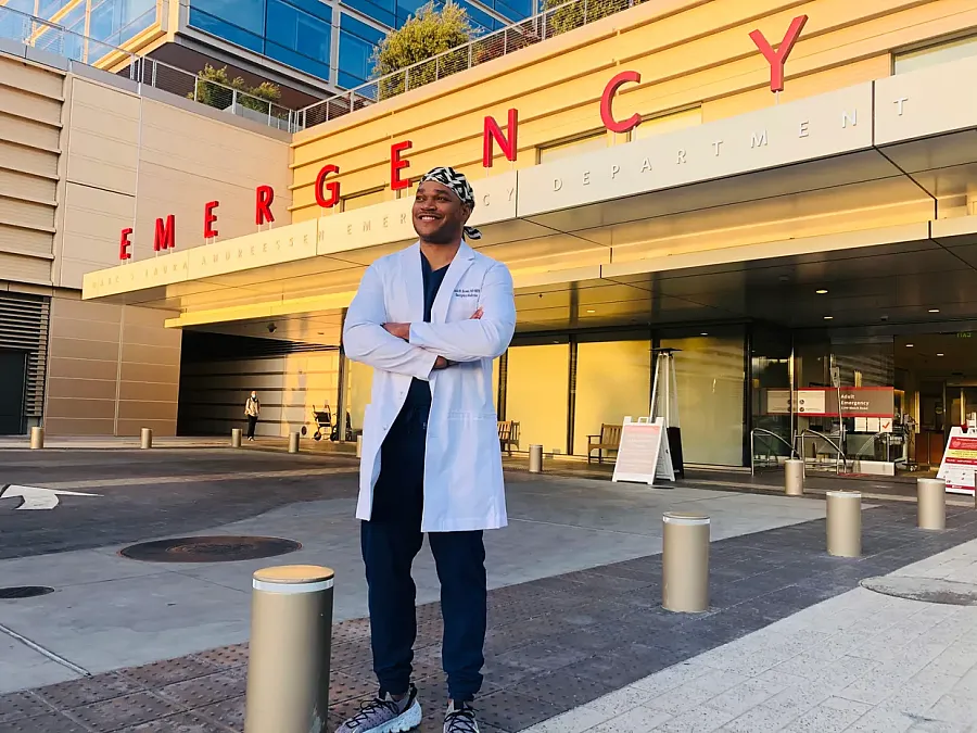 A doctor standing in front of emergency building 