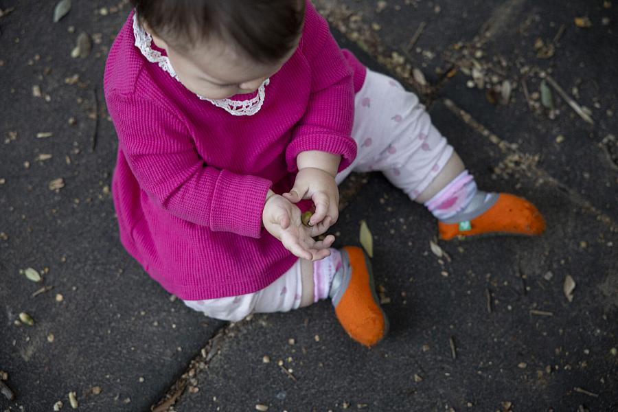 Edith, 10 months, plays with dirt 