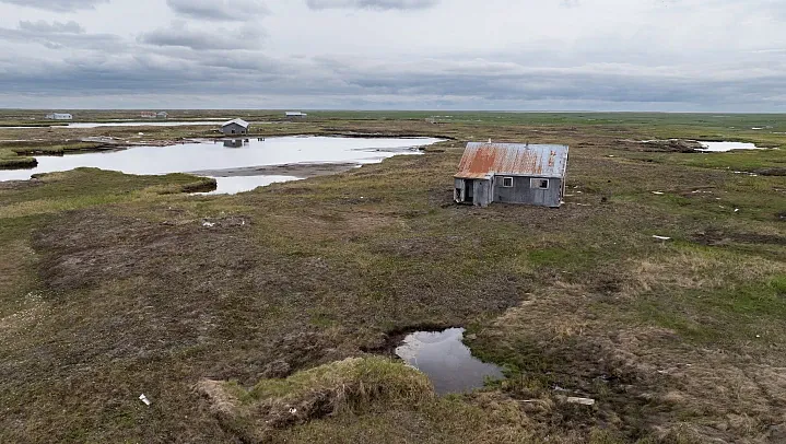 Houses are scattered across the tundra near Kwigillingok, Alaska