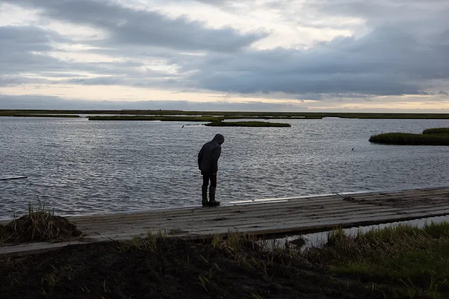 A men standing by the river 
