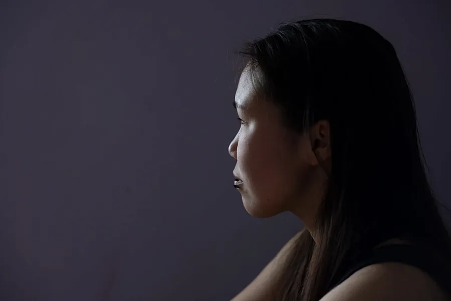 Ariel Friend, 20, sits on her bed in a room she shares with her aunt in Bethel, Alaska